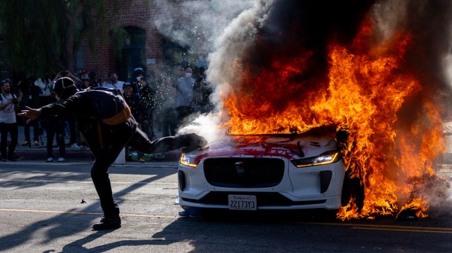 Waymo car on fire during Los Angeles protests