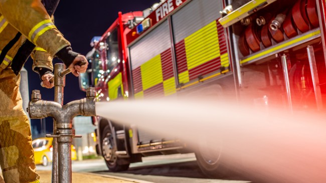 Firefighter at water hydrant next to truck
