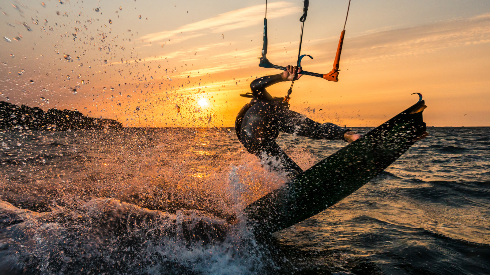 kite surfer in front of a sunset